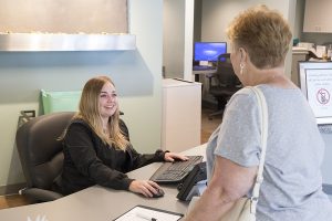 Front desk staff greeting patient
