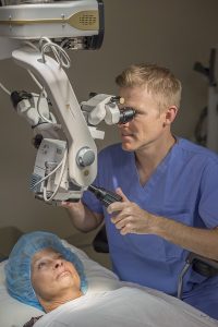 Doctor using machine to look at patients eyes