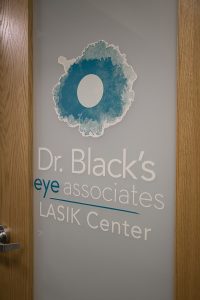 Logo of Dr. Black's eye associates LASIK Center logo on door